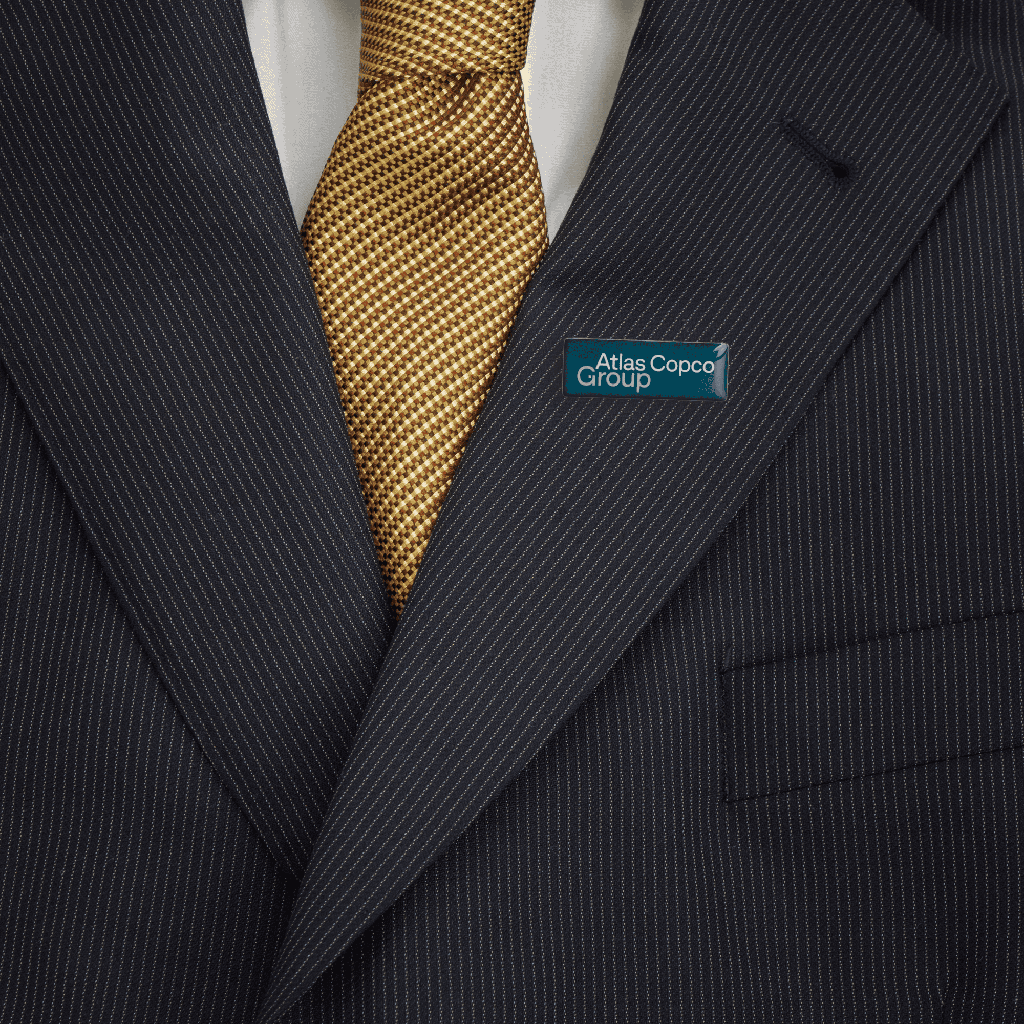 metal pin with atlas copco group logo on jacket
