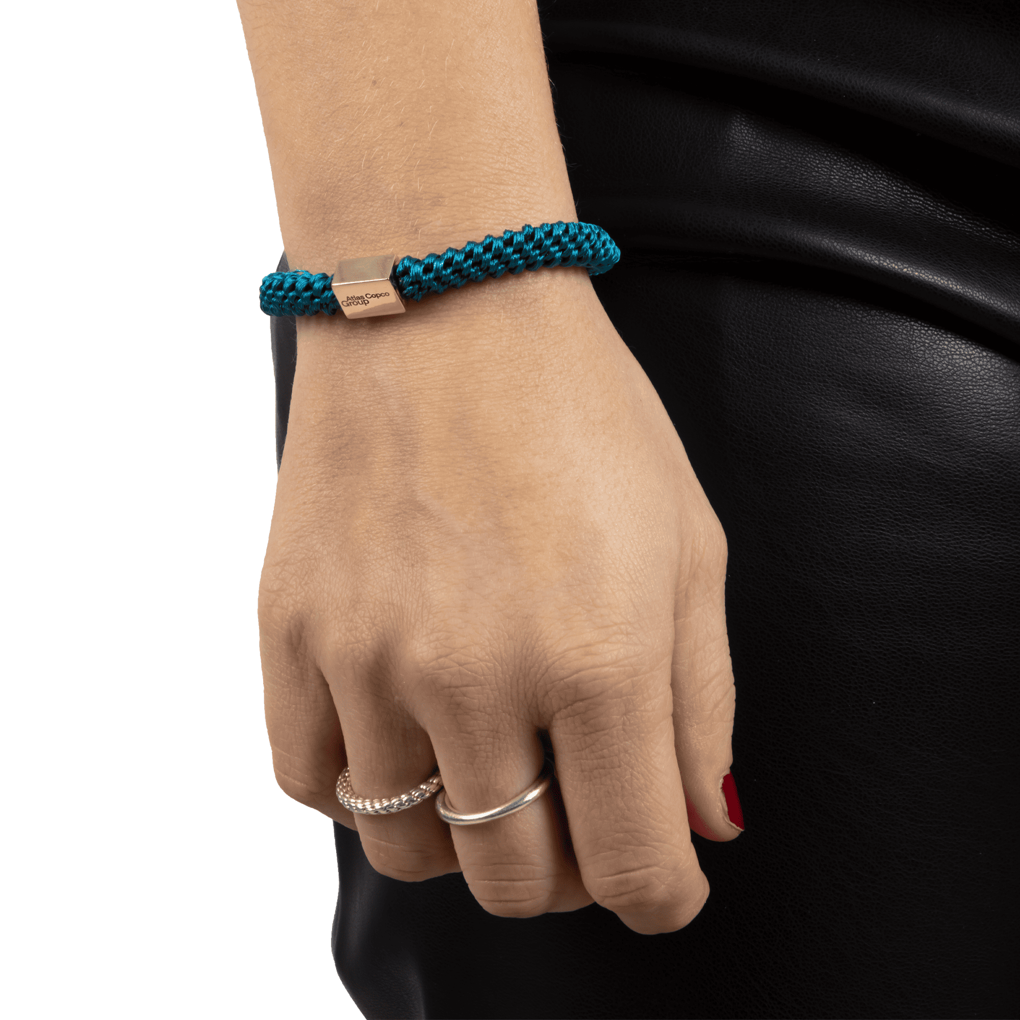 teal hair tie with golded box and atlas copco group logo on arm