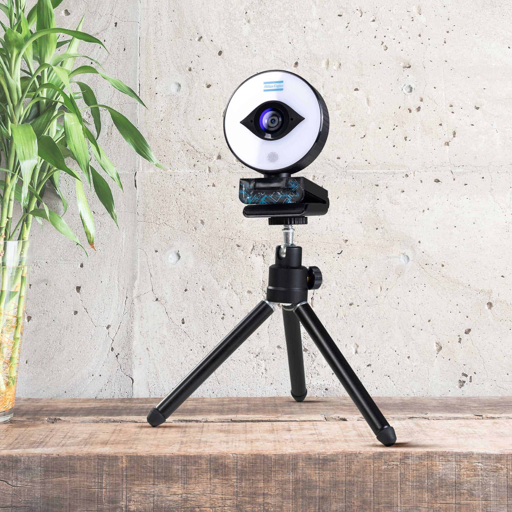 webcam with blue atlas copco logo and stand